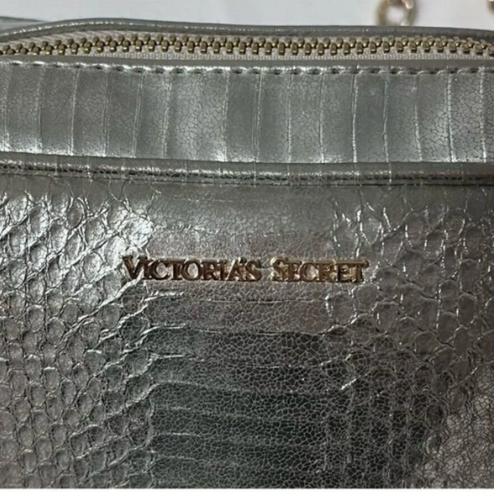 Victoria’s Secret silver snake skin purse with gold chain strap.
